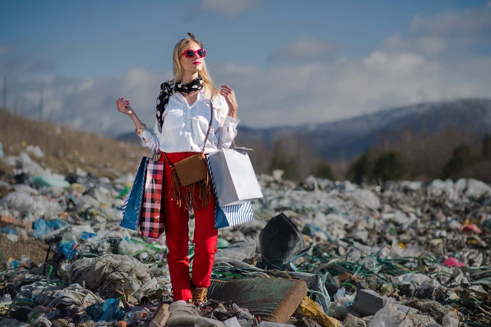 modern woman on landfill, consumerism versus pollution concept. modern woman on landfill, consumerism versus pollution concept.